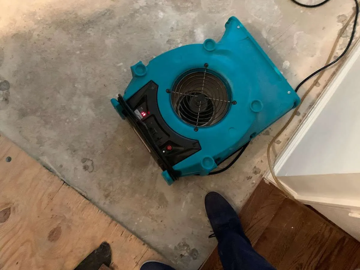 Air mover drying subfloor during Leak Detection & Repair in Tehaleh